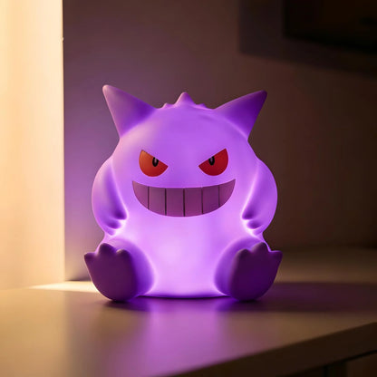 Gengar Pokémon LED night light glowing purple on bedside table, anime lamp for bedroom decor and kawaii room lighting gift