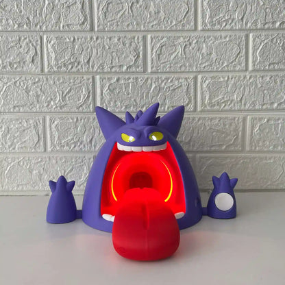Gengar-inspired wireless charging stand with red LED lighting on, front view on desk background